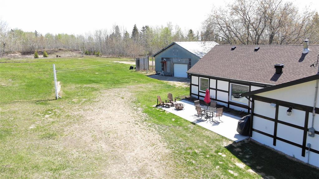 Backyard at 117031 17E Road with patio and the 40 by 28 ft workshop