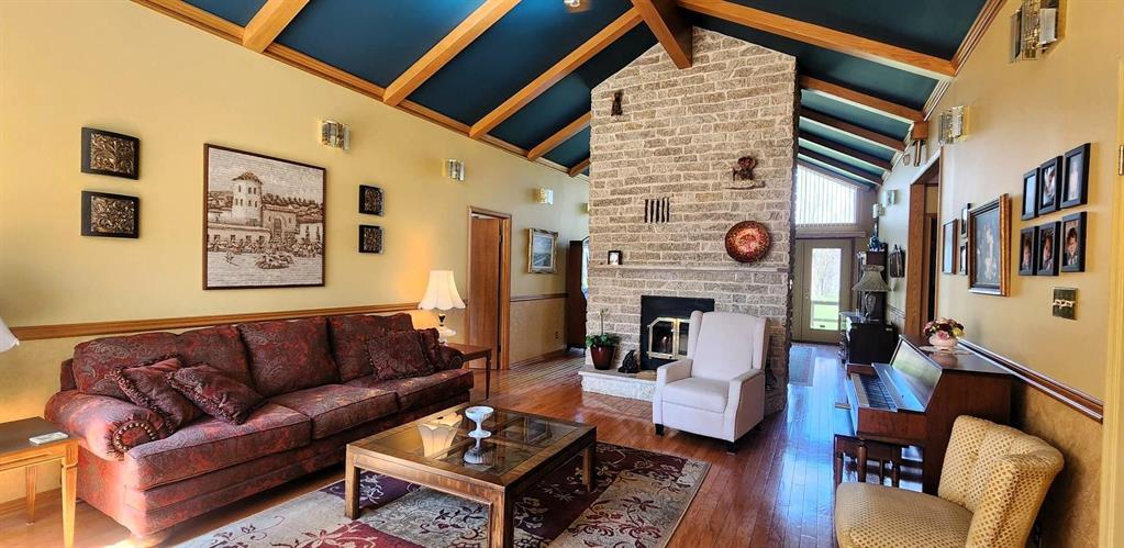 Living room at 17 Nicklaus Close with stone wood-burning fireplace and soaring vaulted ceiling
