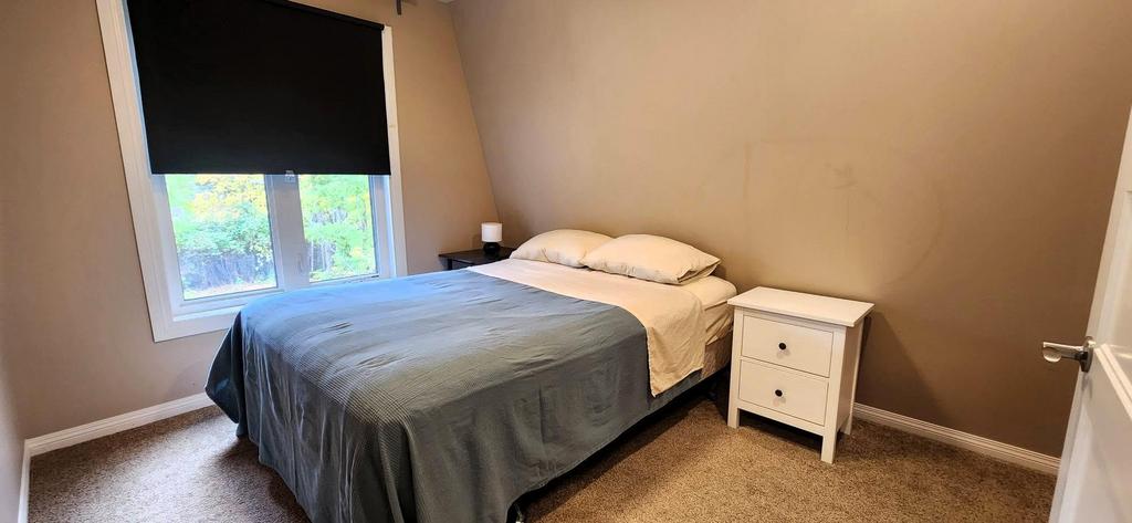 189 6th Street, Gimli &middot; second bedroom with a queen bed
