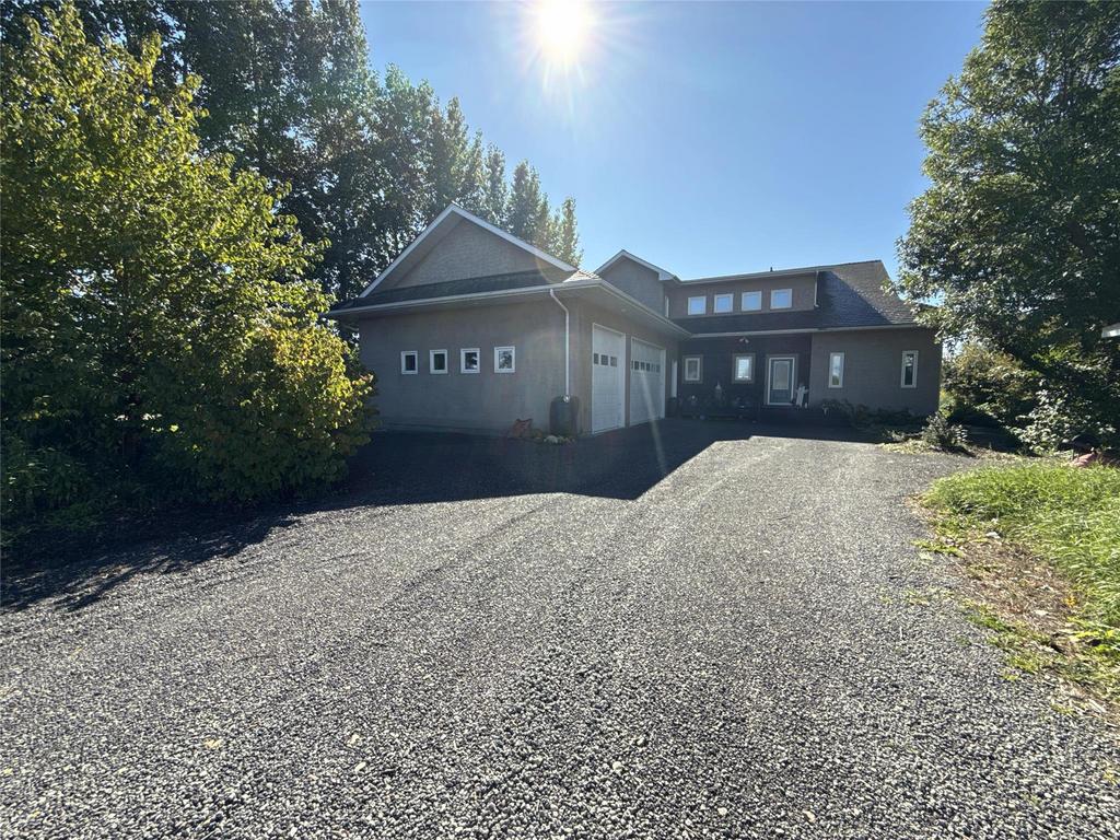 20053 Minerva Road &middot; the gravel driveway running up to the house between the trees