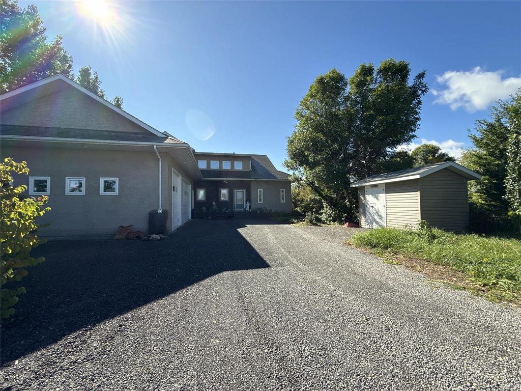 20053 Minerva Road &middot; the front of the house from the driveway, with the storage shed to the right