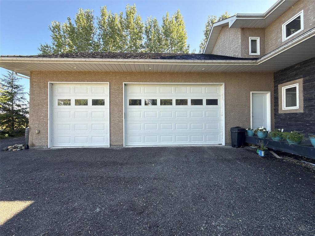 20053 Minerva Road &middot; the triple attached garage with three white doors