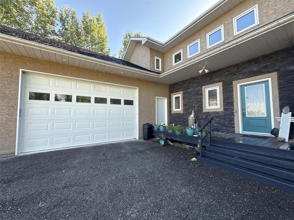 20053 Minerva Road &middot; the front entry with its teal door, beside the garage