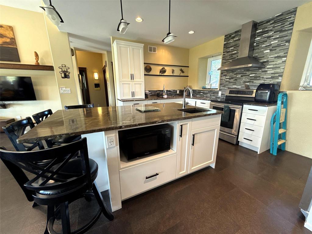 20053 Minerva Road &middot; the kitchen from the dining side, island seating and stainless appliances