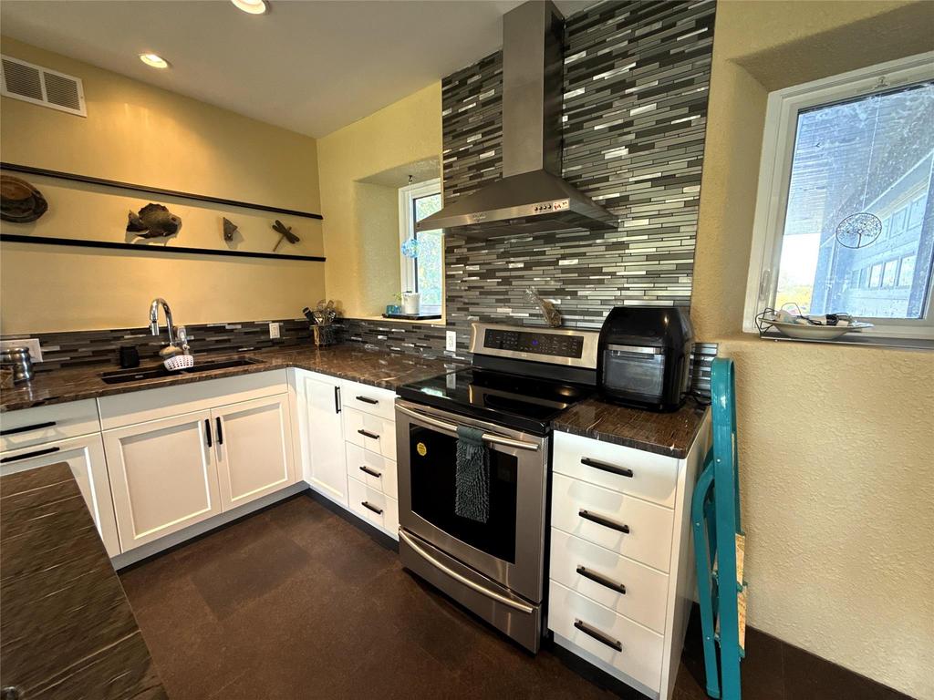 20053 Minerva Road &middot; the kitchen corner with tile backsplash, range hood and a window over the counter