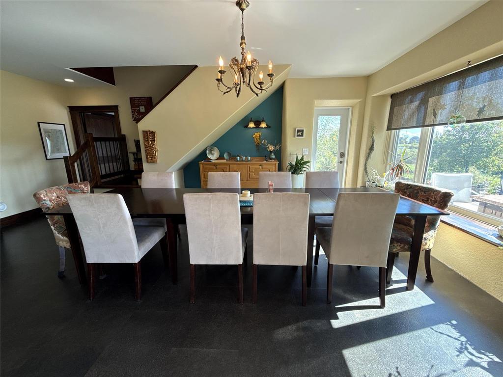 20053 Minerva Road &middot; the dining table with upholstered chairs and the water beyond