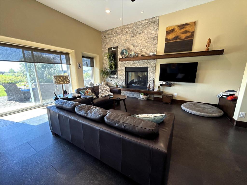 20053 Minerva Road &middot; the living room with its stone gas fireplace under a vaulted ceiling