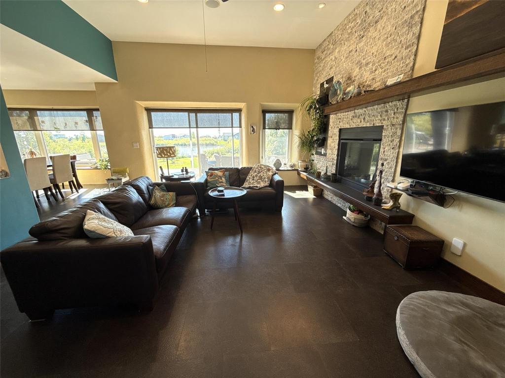 20053 Minerva Road &middot; living room seating by the fireplace, with the water-view windows