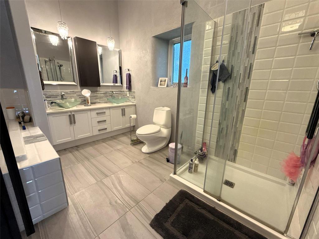 20053 Minerva Road &middot; the ensuite with a double vanity, glass shower and tiled floor