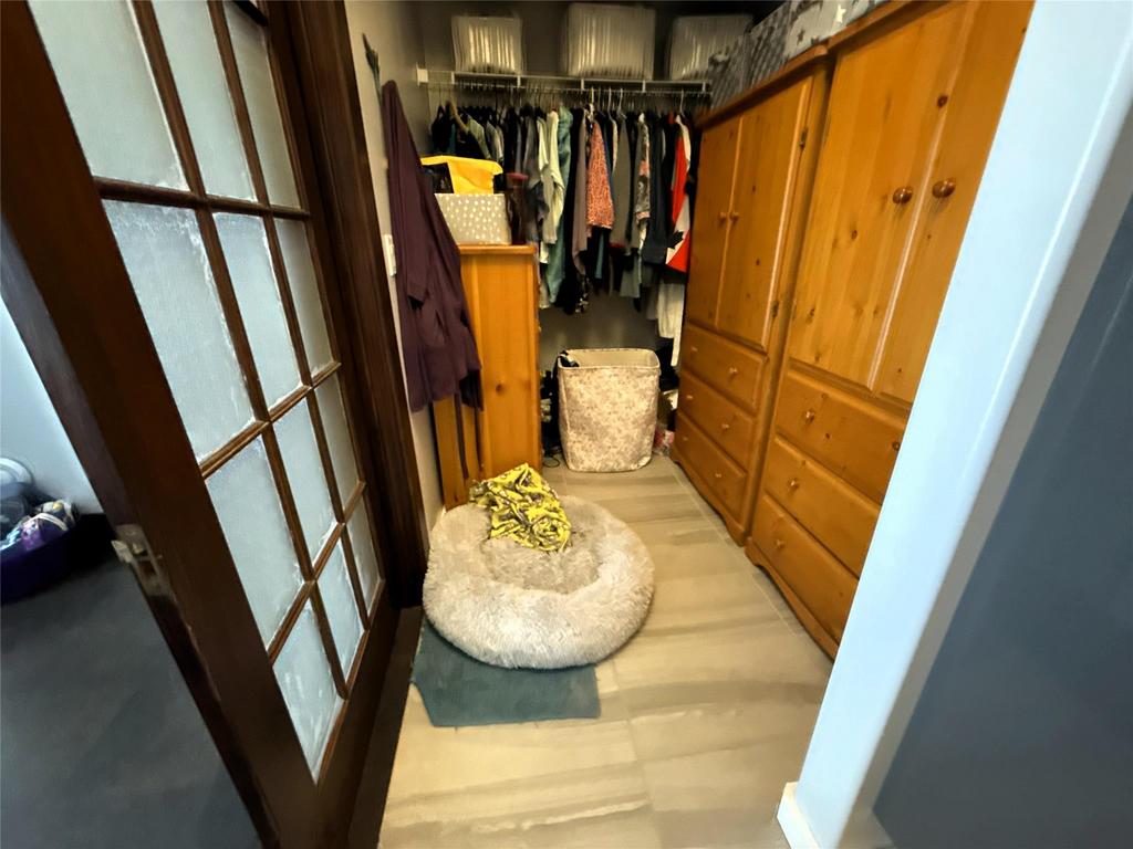 20053 Minerva Road &middot; the walk-in closet, with hanging space and a wood wardrobe