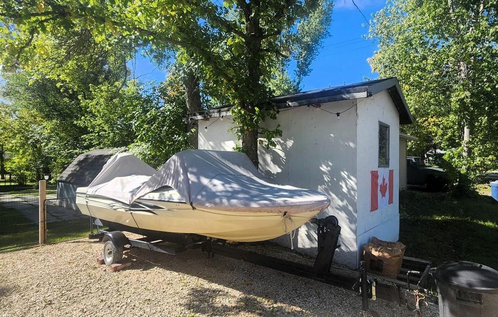 241 Maple Avenue &middot; the white shed, with the boat and trailer alongside
