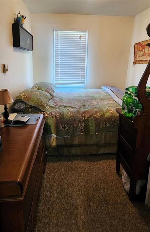 310 Epsilon Avenue, Winnipeg Beach &middot; Second bedroom with a bed and dresser beside the window