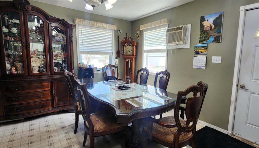 310 Epsilon Avenue, Winnipeg Beach &middot; Dining room with a table and chairs, china cabinet and a wall air conditioner
