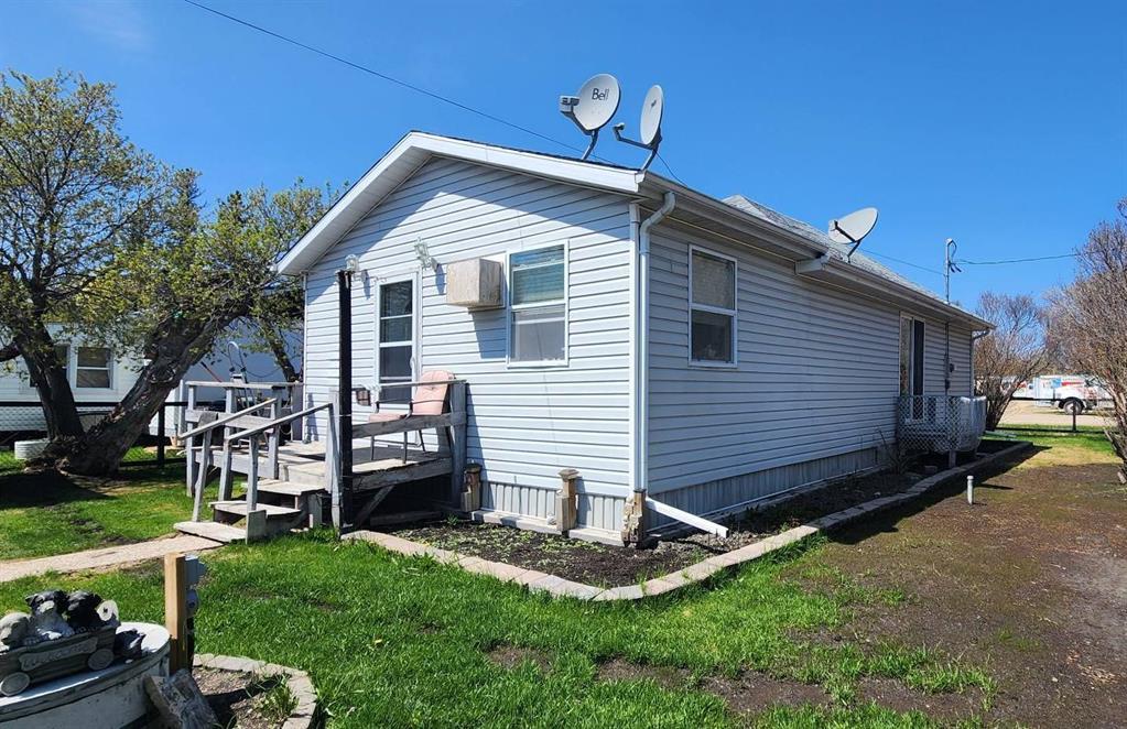 Side view of 310 Epsilon Avenue showing the deck, side entry, and fenced corner lot