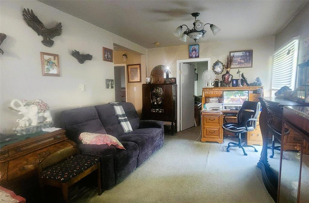 310 Epsilon Avenue, Winnipeg Beach &middot; Living room with a sectional sofa, ceiling fan and a desk area beyond