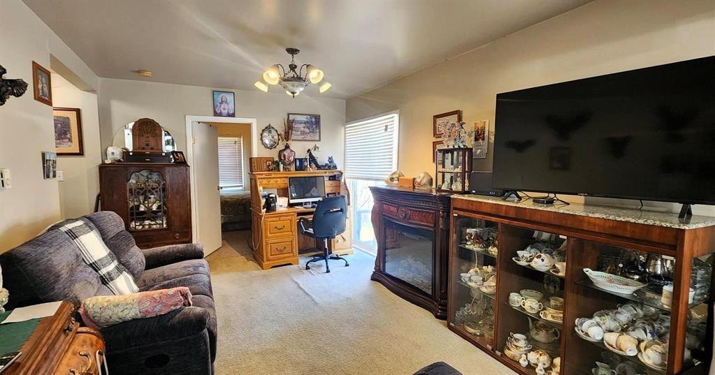 310 Epsilon Avenue, Winnipeg Beach &middot; Living room from the other side, looking through to the desk area and hallway