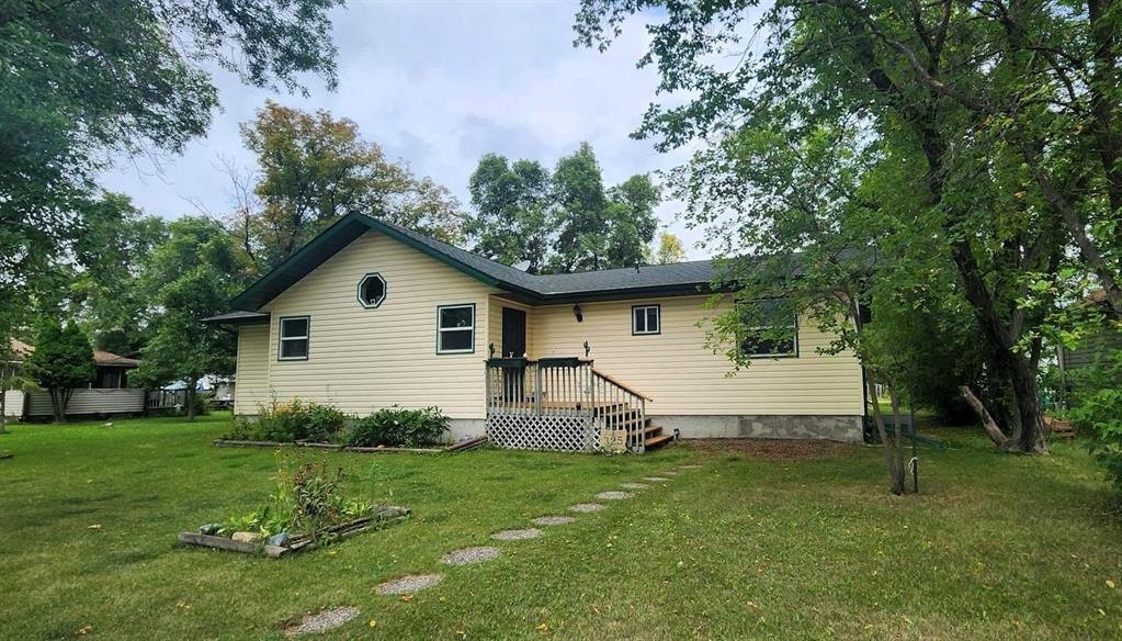 325 Epsilon Avenue, Winnipeg Beach &middot; the home from the road, with the walkway to the front deck