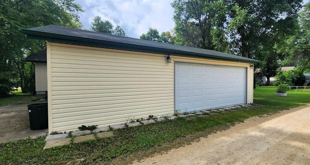 325 Epsilon Avenue, Winnipeg Beach &middot; the detached garage from the side, with the gravel drive