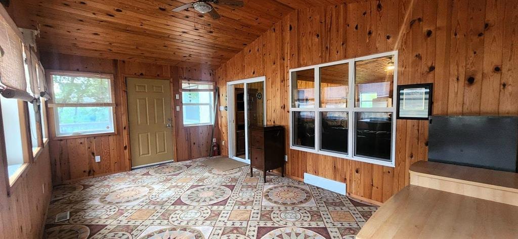 325 Epsilon Avenue, Winnipeg Beach &middot; sunroom from the other end, with the door through to the yard