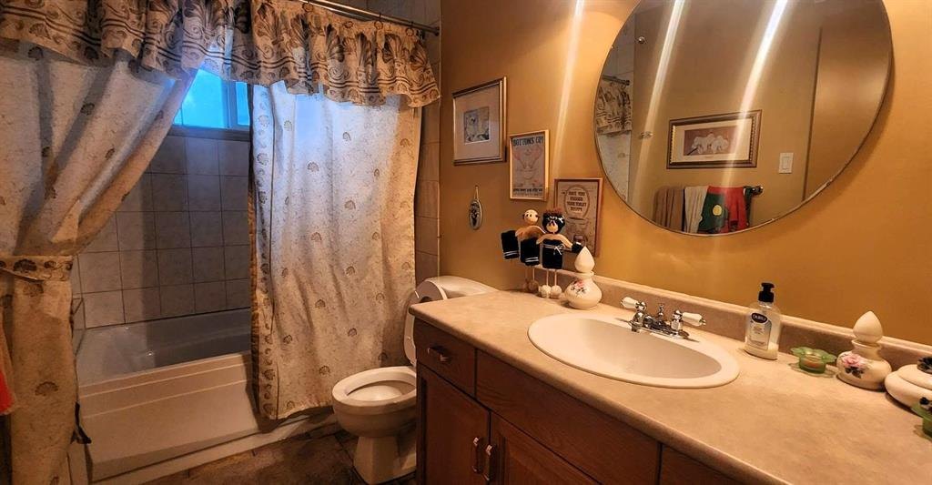 325 Epsilon Avenue, Winnipeg Beach &middot; main bathroom with a tub and shower, vanity and round mirror