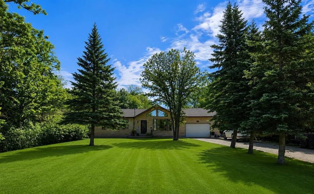 34 Nicklaus Drive, Sandy Hook · front of the home from the lawn, attached garage and spruce trees