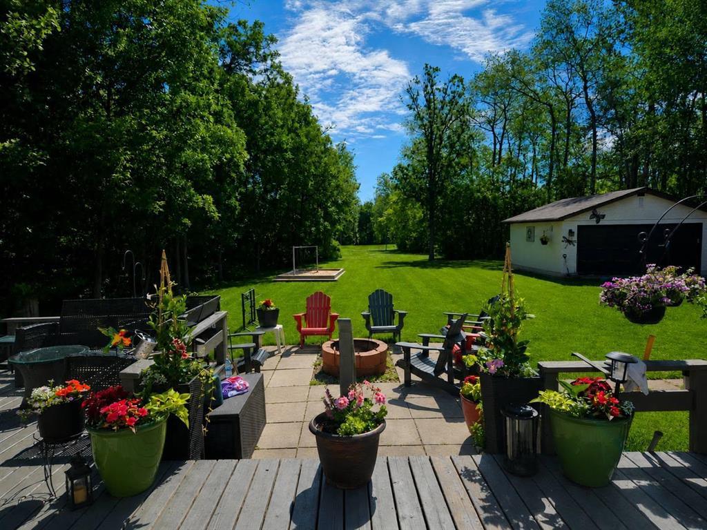 34 Nicklaus Drive, Sandy Hook · view from the deck across the firepit and lawn to the detached garage