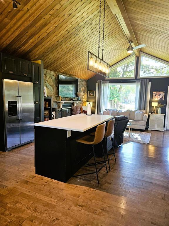 34 Nicklaus Drive, Sandy Hook · kitchen island and seating, with the stone fireplace wall beyond