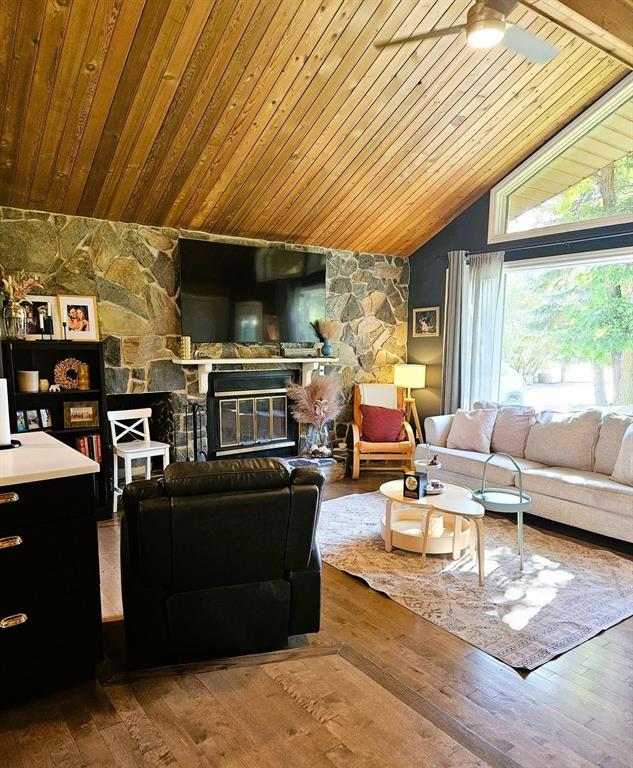 34 Nicklaus Drive, Sandy Hook · living room with the stone fireplace wall and vaulted wood ceiling