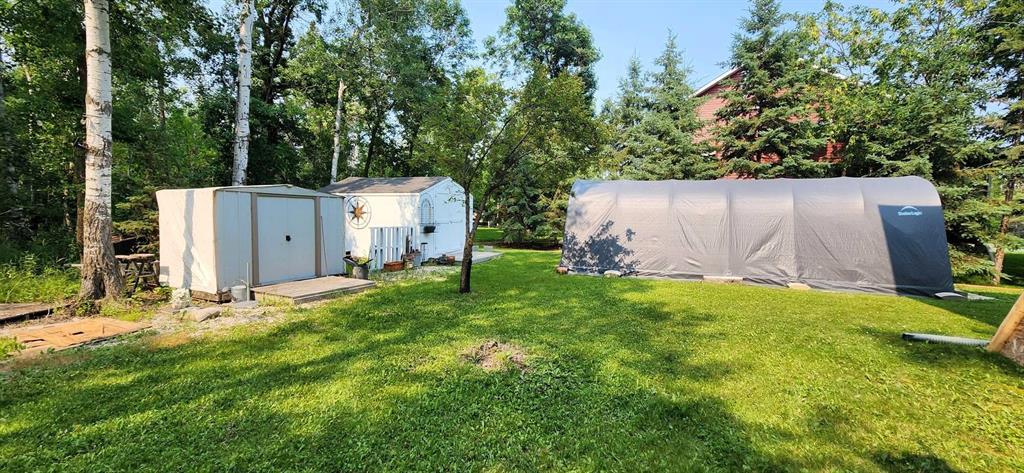 35 Thorvaldson Drive, Arnes · two storage sheds and the canvas portable garage