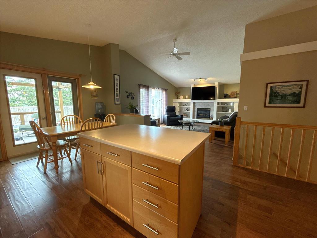 40 Forestgate Avenue, Linden Woods · kitchen island with the living room and fireplace beyond under vaulted ceilings