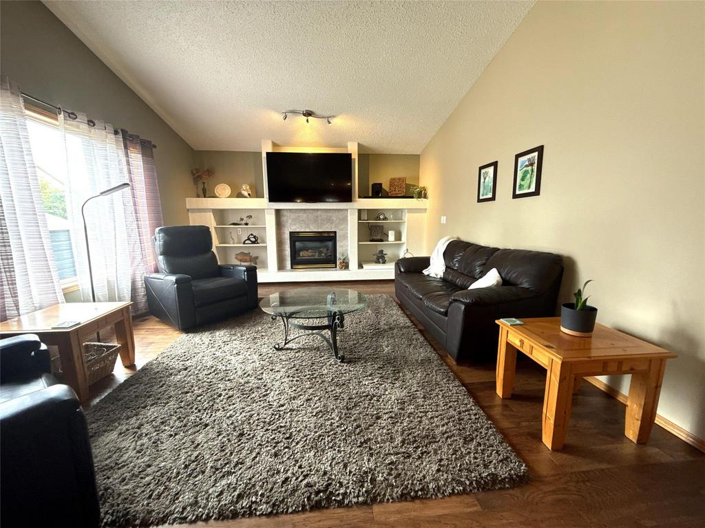 40 Forestgate Avenue, Linden Woods · living room with a gas fireplace framed by built-in shelving