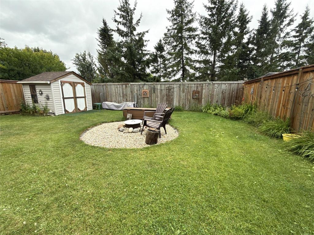 40 Forestgate Avenue, Linden Woods · back yard with the shed, firepit and mature spruce along the fence