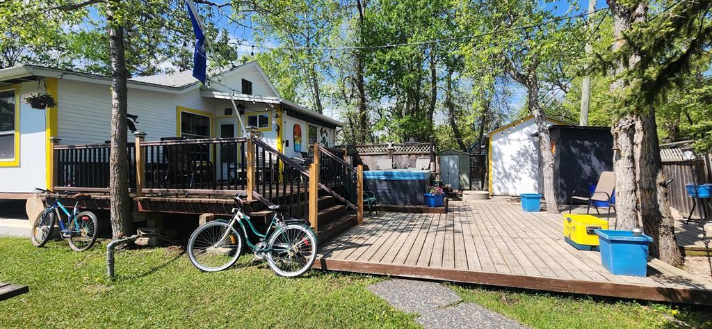The backyard at 405 Silverdale Avenue, with a two-tier deck, hot tub, and fenced yard