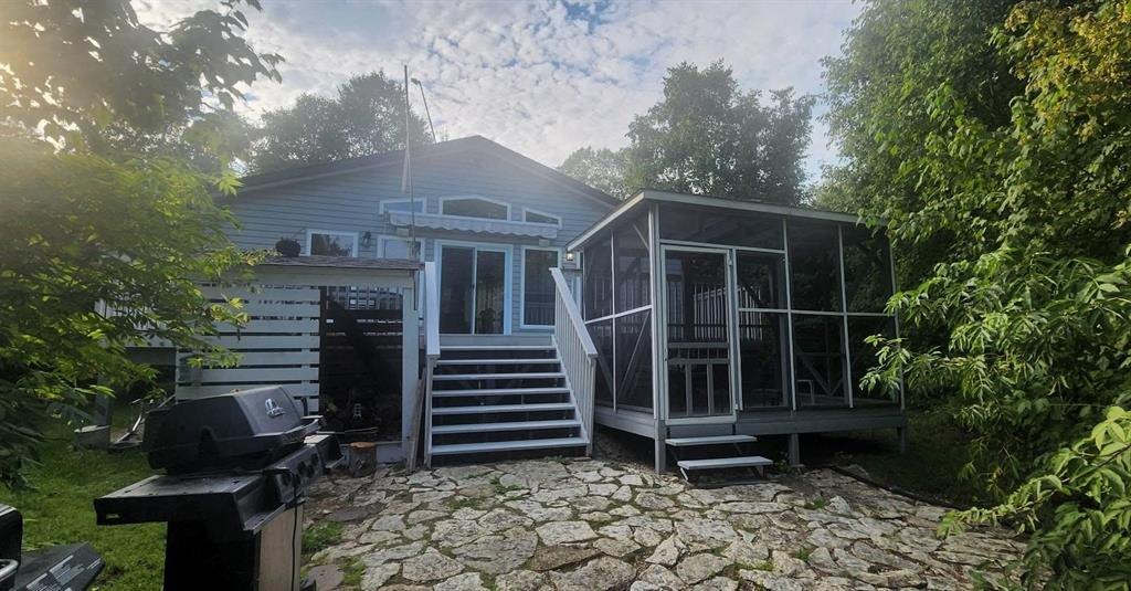 41 Little Deer Road &middot; the cabin from the stone patio, with the screen room and barbecue area