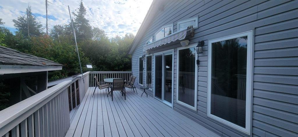 41 Little Deer Road &middot; the long lake-facing deck running the length of the cabin, with patio seating