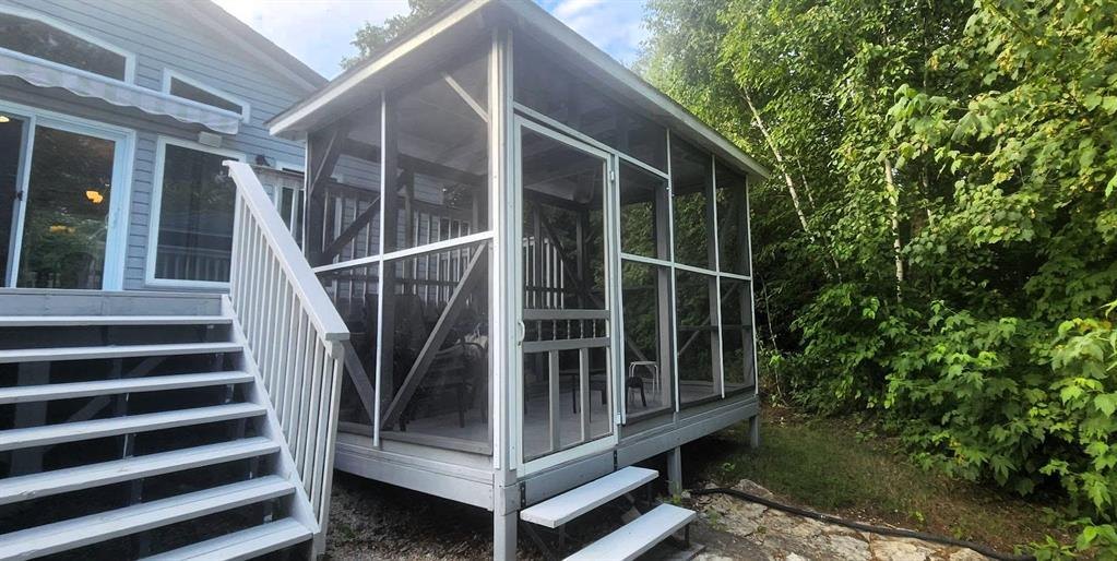 41 Little Deer Road &middot; the screen room off the deck, with steps down to the yard