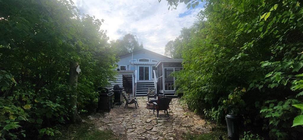 41 Little Deer Road &middot; stone patio and seating on the approach to the cabin