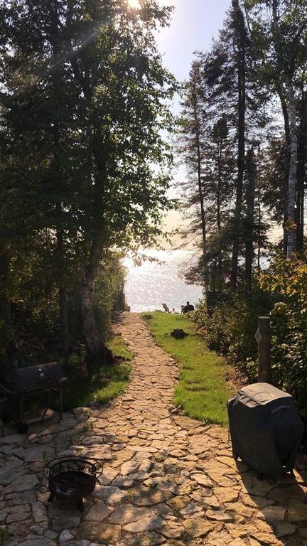 41 Little Deer Road &middot; stone path leading down through the trees to the shoreline