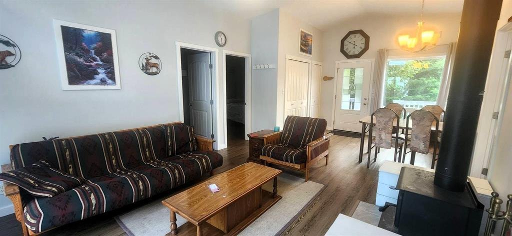 41 Little Deer Road &middot; living room with sofas, wood stove and the dining area beyond