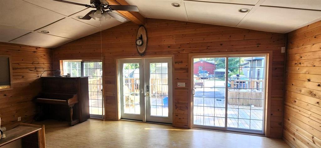 418 Oak Avenue, Winnipeg Beach · sunroom with vaulted ceiling, pine walls, french doors and a patio door to the deck