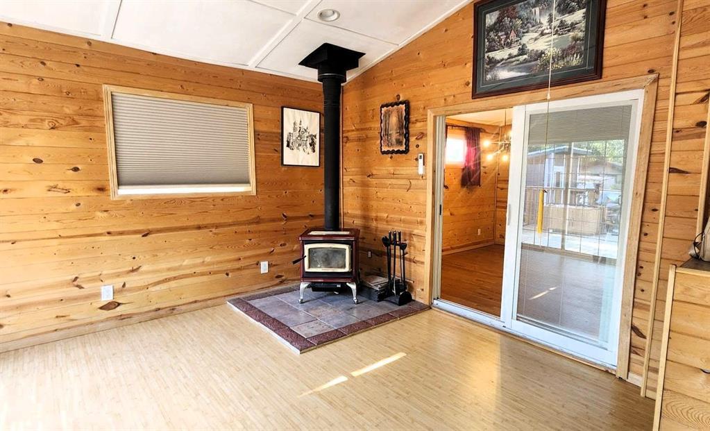 418 Oak Avenue, Winnipeg Beach · sunroom with the free-standing wood stove on a tile hearth