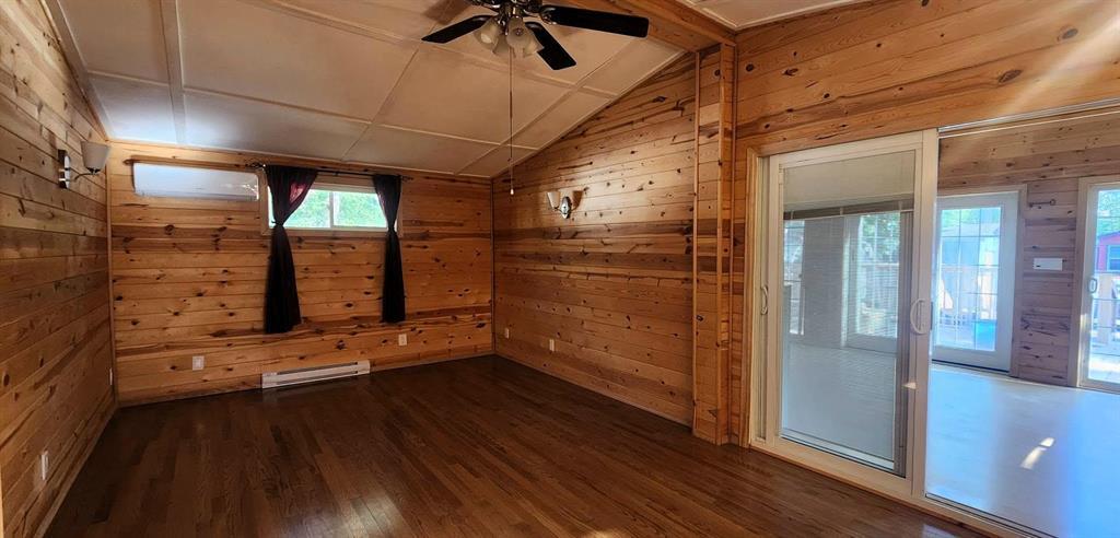418 Oak Avenue, Winnipeg Beach · living room with pine walls, wood flooring and a ductless mini-split