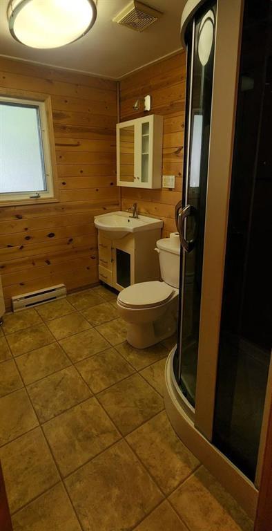 418 Oak Avenue, Winnipeg Beach · bathroom with a corner shower stall, vanity and tile flooring