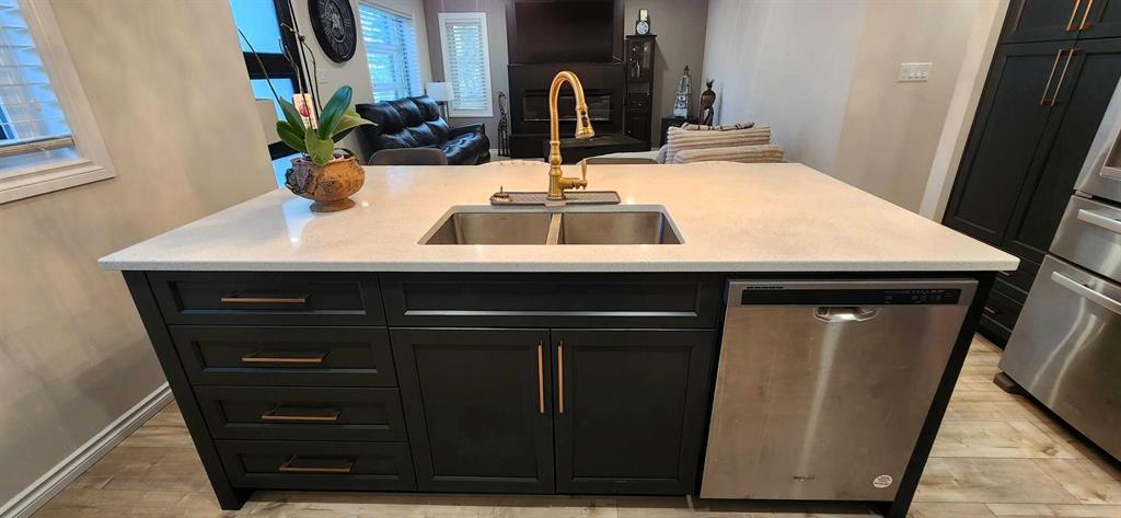 Quartz island detail at 529 Ash Avenue with undermount sink and gold faucet