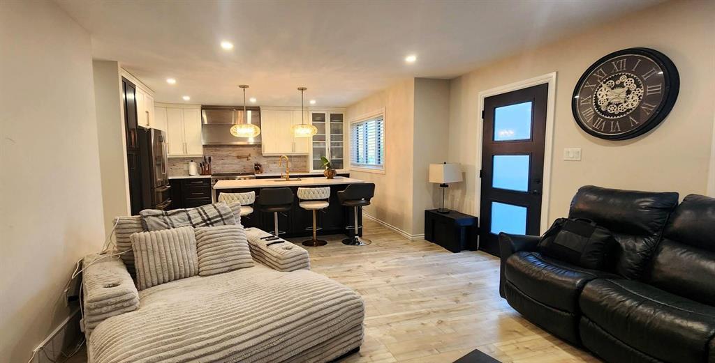 Open living room and kitchen at 529 Ash Avenue with quartz island and pendant lighting