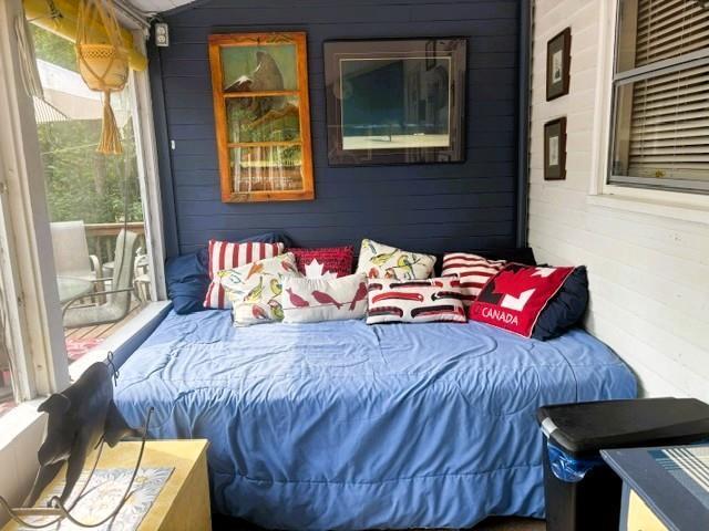 560 Prospect Street, Winnipeg Beach · daybed tucked into a corner of the porch beside the windows