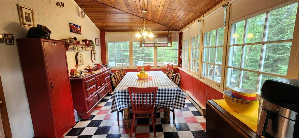 560 Prospect Street, Winnipeg Beach · dining room with a long table, wood ceiling and checkerboard floor