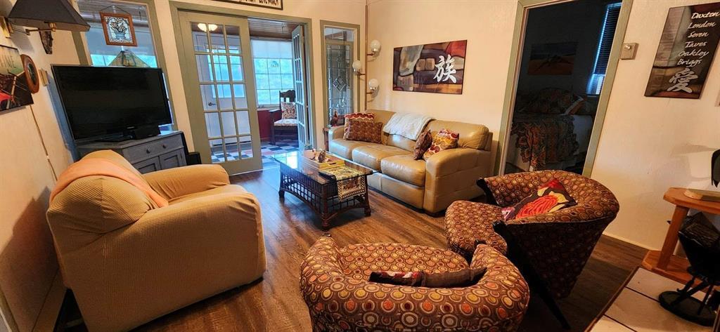 560 Prospect Street, Winnipeg Beach · living room with wood flooring and doors through to the porch