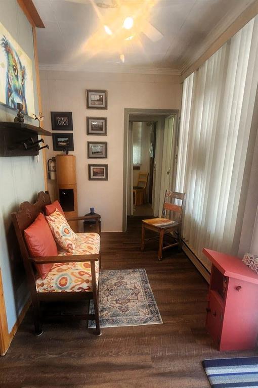 560 Prospect Street, Winnipeg Beach · sitting room with an armchair and a doorway through the cottage