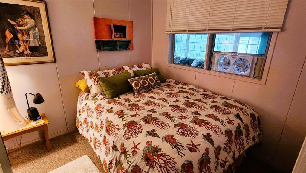 560 Prospect Street, Winnipeg Beach · bedroom with a double bed and windows to the yard